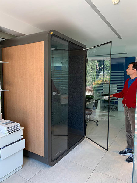 A man visiting soundbox's khaki office privacy pods