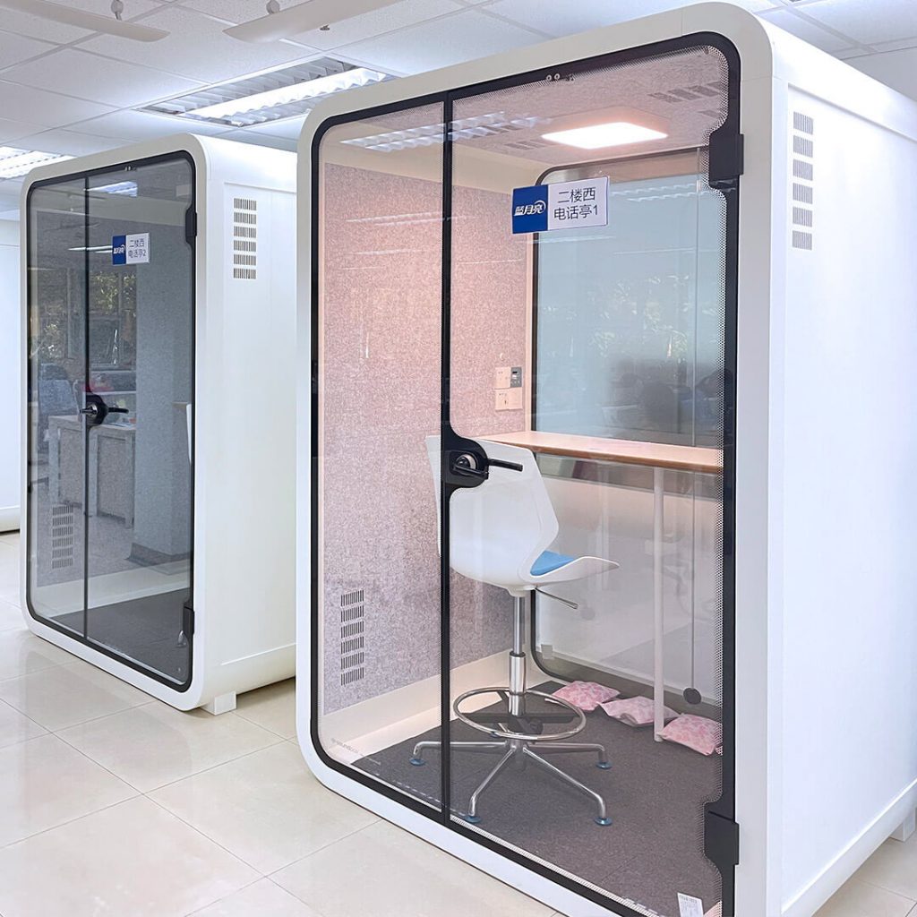 Two soundbox's white medium office pods are placed in office