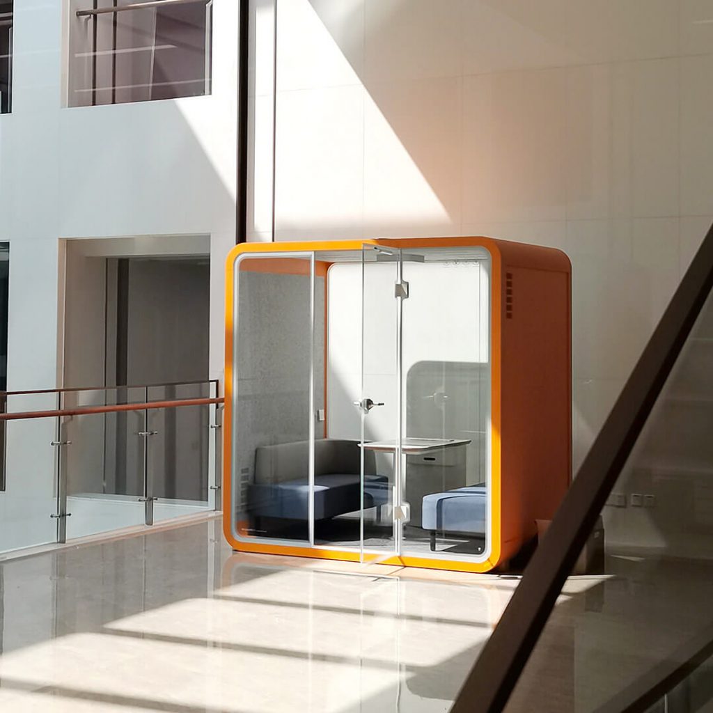 Soundbox's large orange silence booth is placed in library